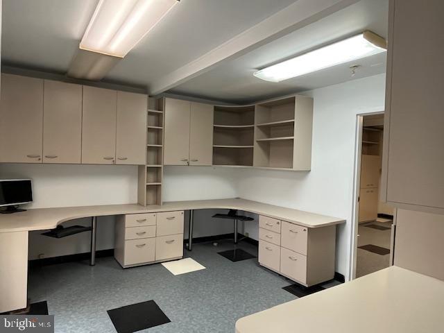 unfurnished office featuring built in desk