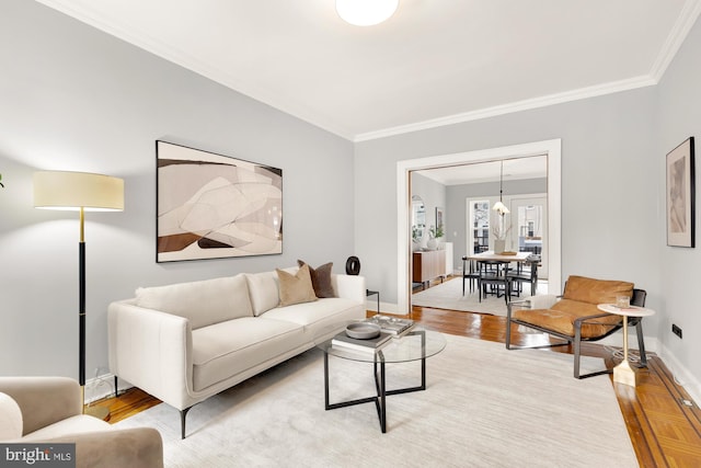 living room with wood-type flooring and ornamental molding