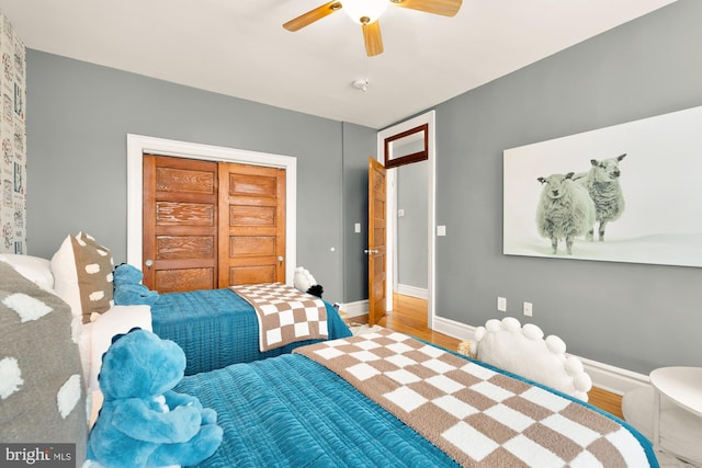 bedroom with a closet, ceiling fan, and hardwood / wood-style floors