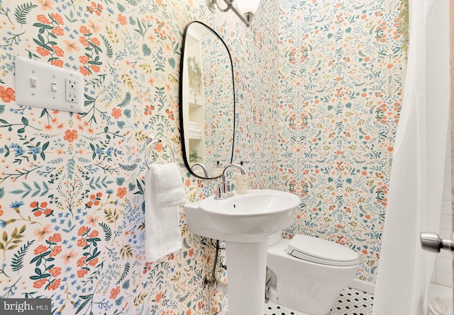 bathroom with toilet and tile patterned flooring