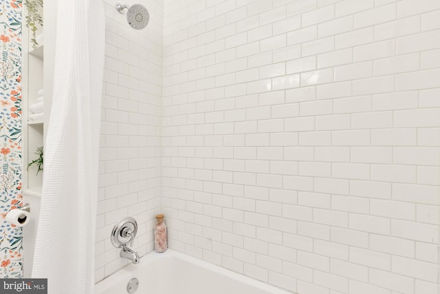 bathroom with shower / bath combo with shower curtain