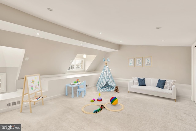 playroom featuring light colored carpet and vaulted ceiling