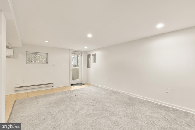 spare room featuring light tile patterned floors, a baseboard radiator, and a wall unit AC