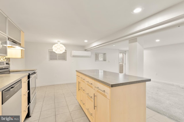 kitchen featuring a center island, light brown cabinets, stainless steel appliances, light colored carpet, and a wall mounted air conditioner