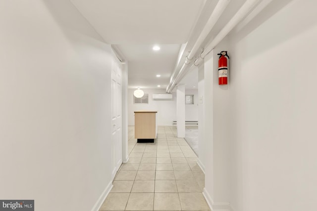 hall featuring a wall mounted air conditioner and light tile patterned floors