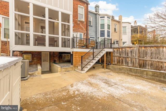 rear view of property featuring central AC unit and a patio