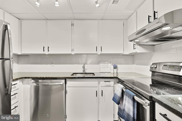 kitchen featuring white cabinetry, appliances with stainless steel finishes, backsplash, and sink