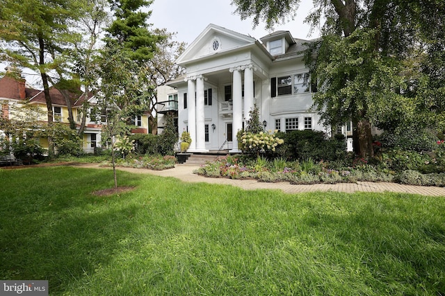 greek revival house featuring a front lawn