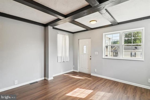 foyer entrance featuring beamed ceiling, dark hardwood / wood-style floors, and coffered ceiling