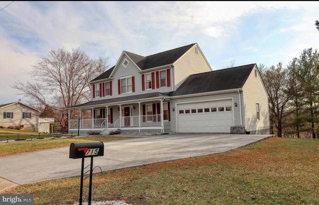 view of front facade featuring covered porch, a garage, and a front yard