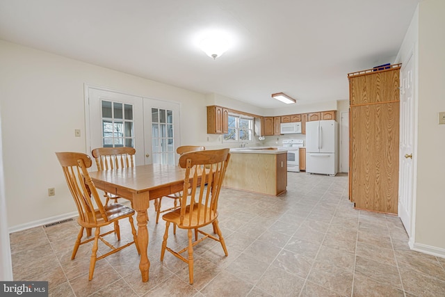 dining space featuring french doors