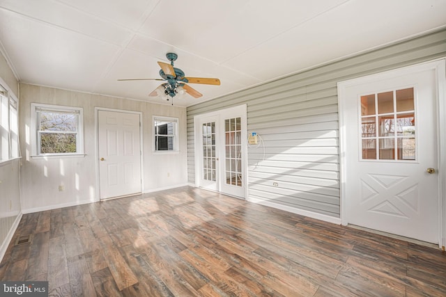 unfurnished sunroom featuring ceiling fan and french doors