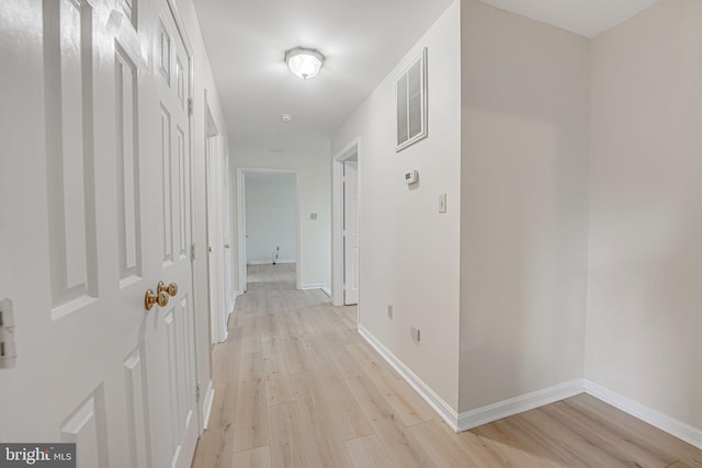 hall with light hardwood / wood-style floors