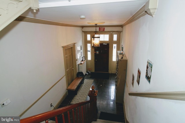 tiled foyer entrance featuring ornamental molding