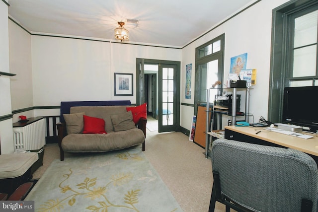 living room featuring french doors and a notable chandelier