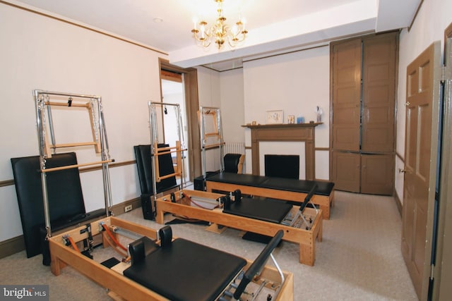 workout area with light carpet and a chandelier