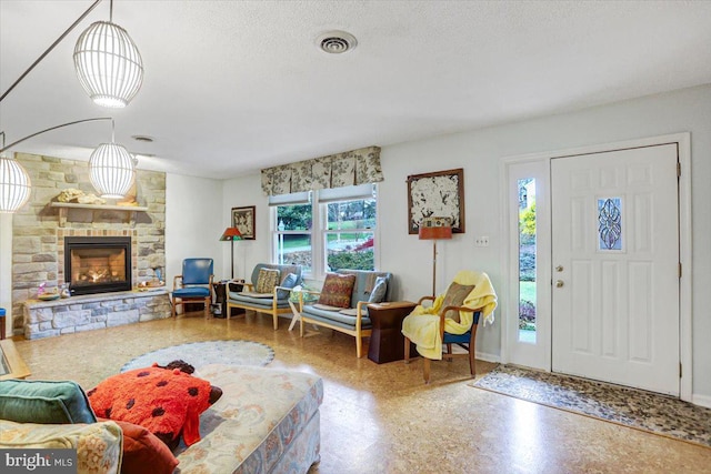 living room with a fireplace and a textured ceiling