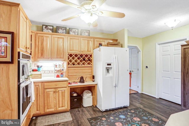 kitchen with ceiling fan, dark hardwood / wood-style flooring, white refrigerator with ice dispenser, a textured ceiling, and light brown cabinetry