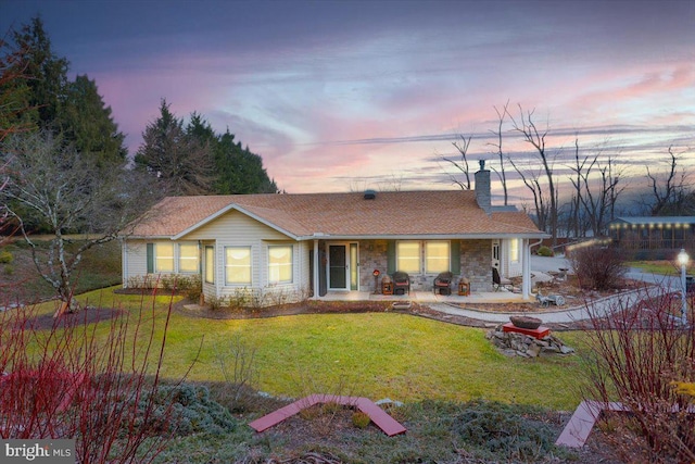 ranch-style house featuring a yard