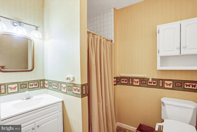 bathroom with vanity, a shower with shower curtain, and toilet