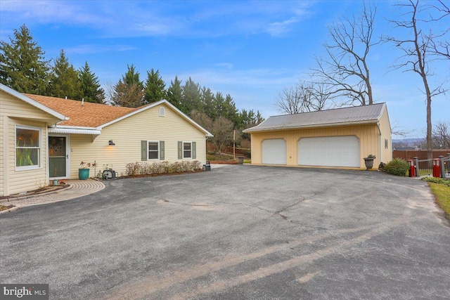 view of side of home with a garage and an outdoor structure