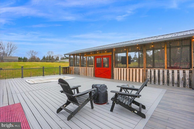 wooden deck with a sunroom