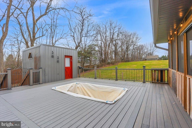 wooden terrace featuring a lawn