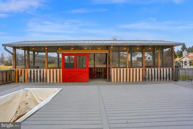 wooden deck with a sunroom