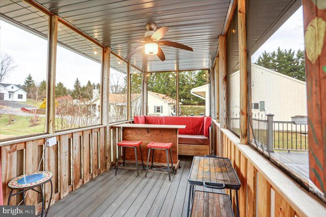 sunroom with a wealth of natural light and ceiling fan