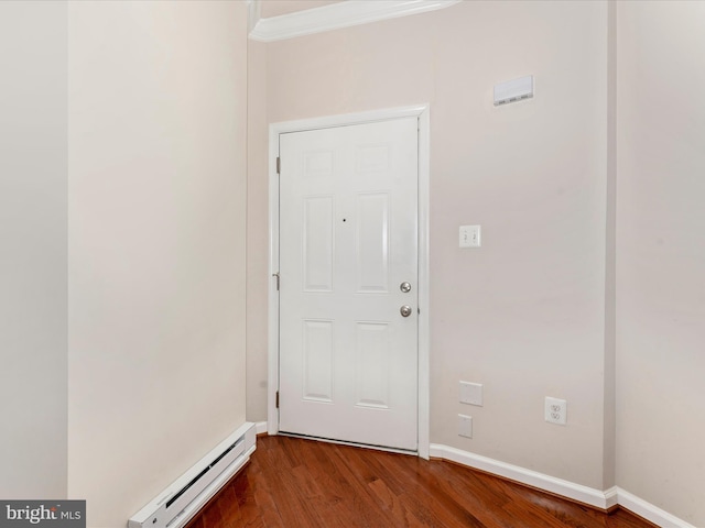 doorway to outside featuring hardwood / wood-style flooring, crown molding, and a baseboard heating unit