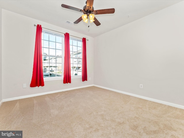 unfurnished room with ceiling fan and light carpet