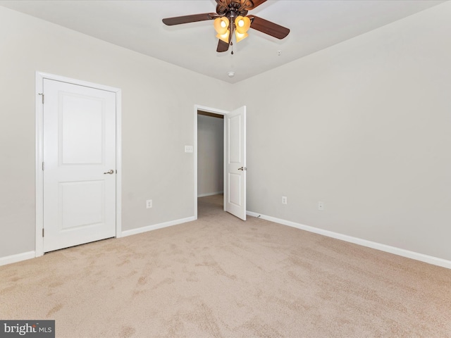 unfurnished bedroom with light colored carpet and ceiling fan