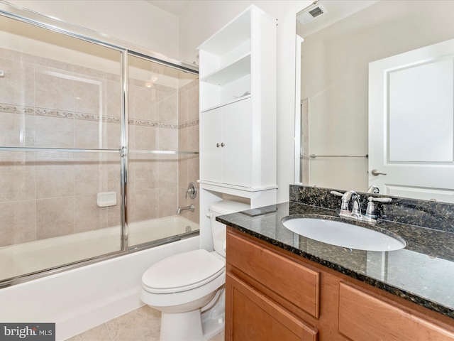 full bathroom with tile patterned floors, vanity, enclosed tub / shower combo, and toilet