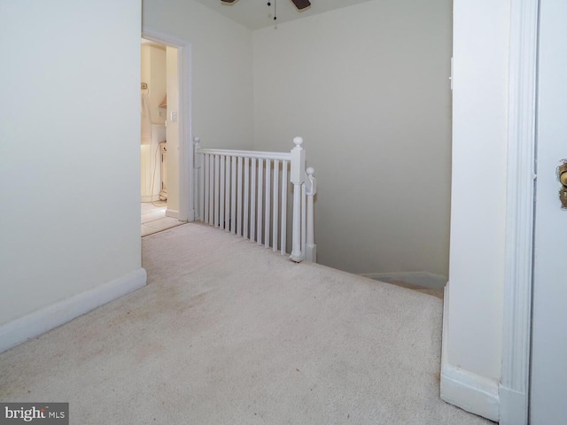 interior space featuring light colored carpet and ceiling fan