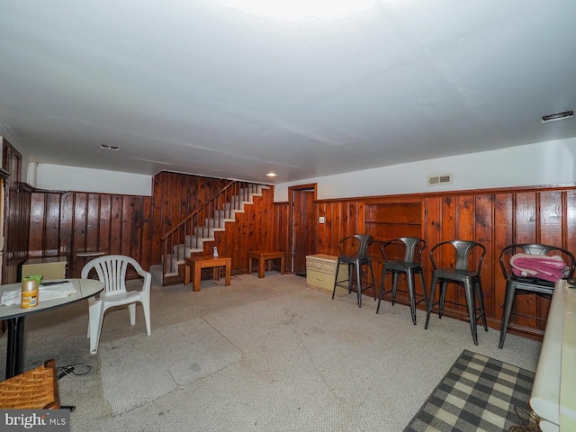 interior space with indoor bar and wood walls