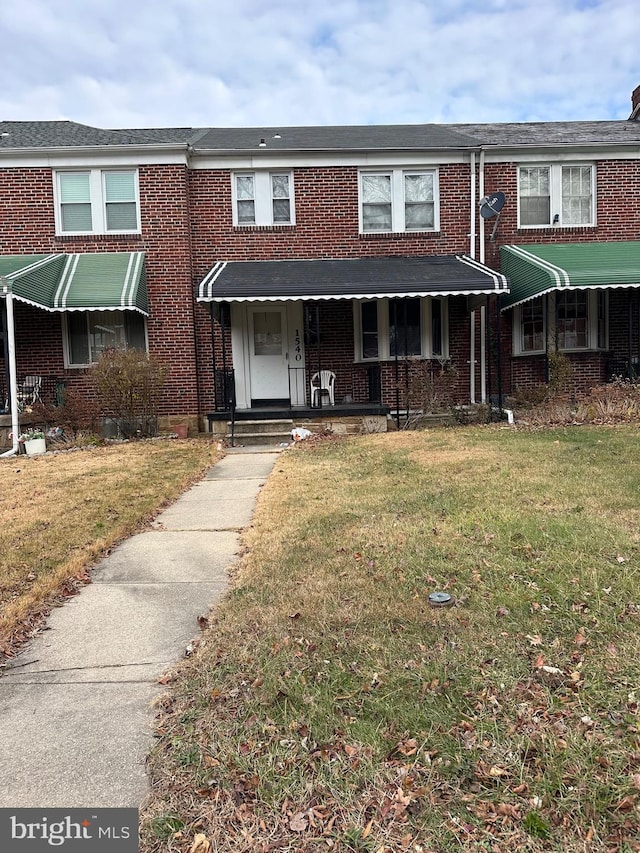 view of property featuring a front lawn