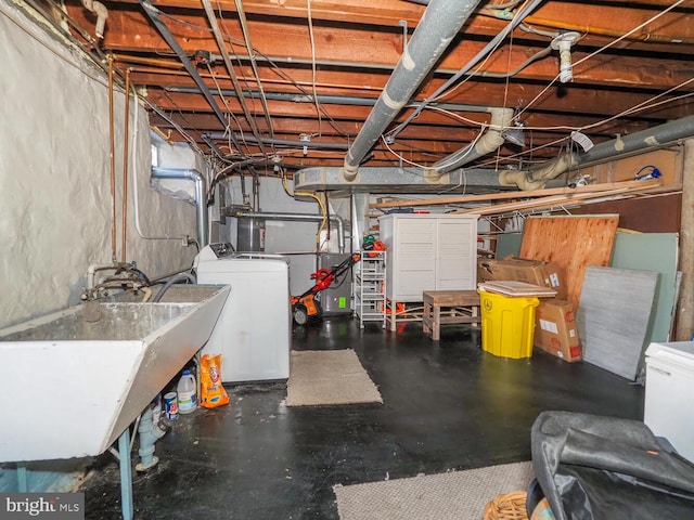 basement featuring sink and washer and clothes dryer