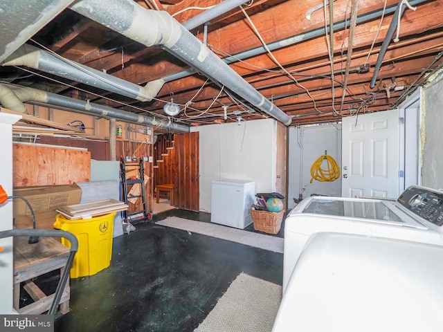 basement featuring fridge and washer and dryer