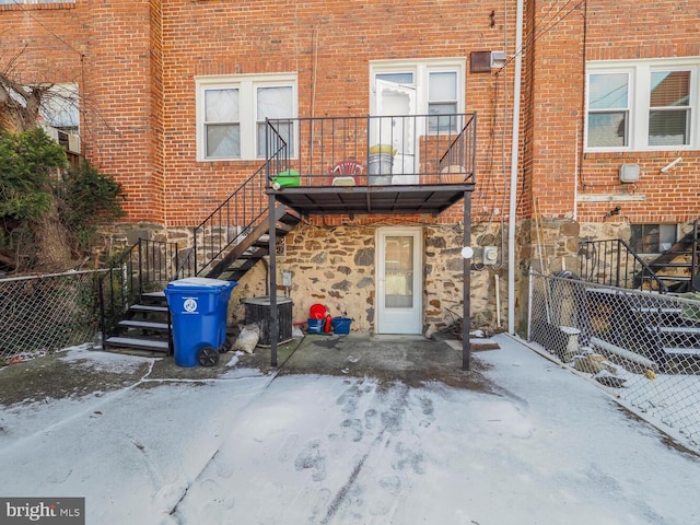 rear view of house featuring a balcony and cooling unit