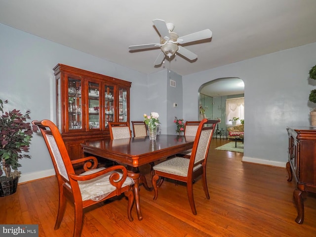 dining space with hardwood / wood-style floors and ceiling fan