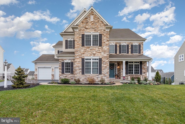 view of front of home with a garage and a front yard