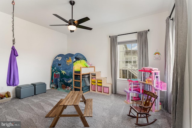 playroom with ceiling fan and carpet