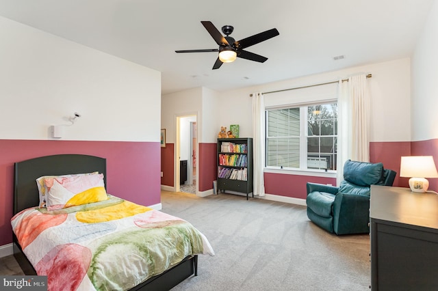 bedroom featuring ceiling fan, light colored carpet, and ensuite bathroom