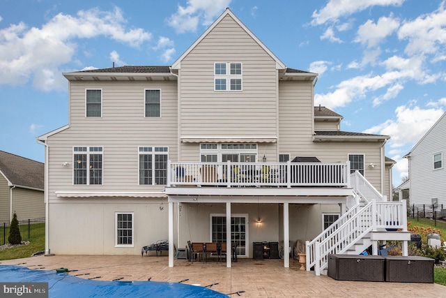 back of house featuring a patio and a wooden deck