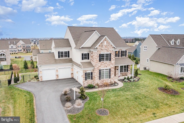 view of front of home featuring a garage and a front yard