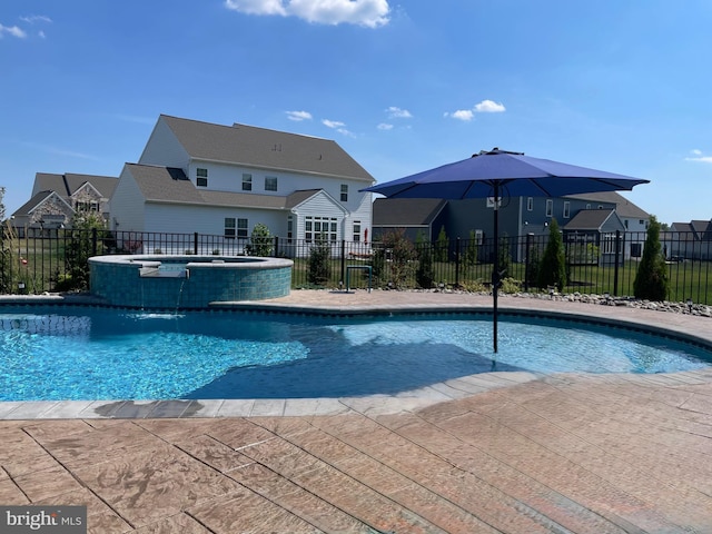 view of swimming pool with an in ground hot tub and pool water feature