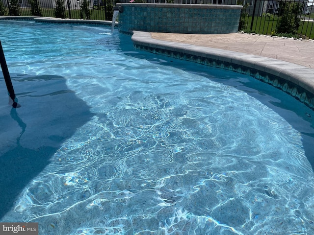 view of pool with pool water feature