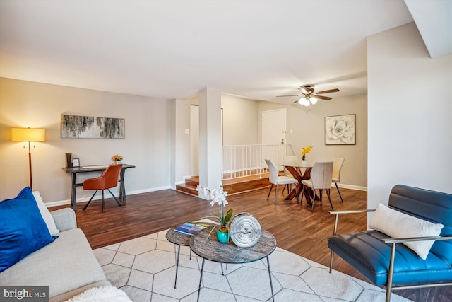 living room featuring hardwood / wood-style flooring and ceiling fan