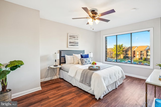 bedroom with ceiling fan and dark hardwood / wood-style flooring