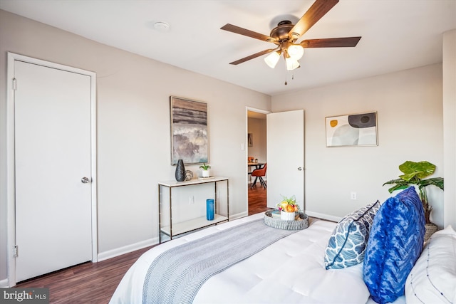 bedroom with ceiling fan and dark hardwood / wood-style floors